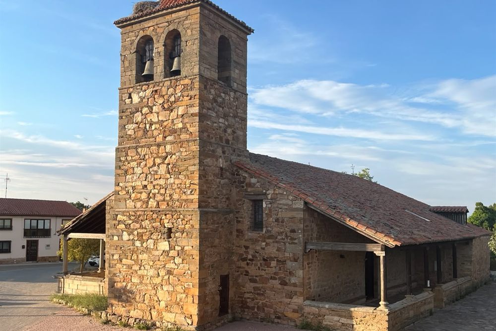 Iglesia de San Miguel Arcángel, con su torre de piedra y el tejado de la nave.